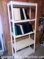 Photo of one plastic shelving unit with 20 assorted binders on two shelves.
