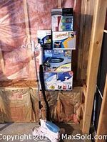Lot of cleaning tools stacked in boxes showing the Black & Decker steamer, Turtle Wax Orbital Polisher box and other boxed cleaning devices