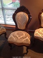Front view of rosewood side chair showing upholstery pattern