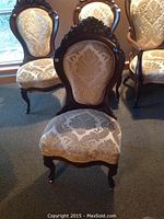Front and back view of four chairs arranged in room