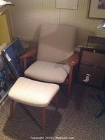 Full front view of armchair with matching footstool