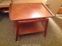 Front view of two-tier teak veneer cart on casters