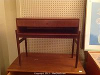 Front view showing drawer and open shelf