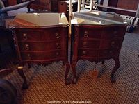 Pair of mahogany side tables grouped together showing front view with glass tops