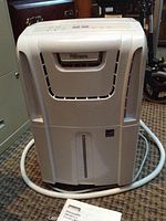 Front view of white Danby dehumidifier showing water reservoir and ventilation.