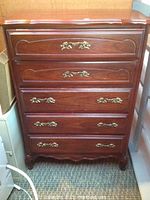 Full front view of the highboy chest showing all five drawers closed and brass handles.