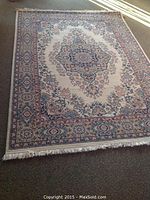 Full view of rug laid flat showing central medallion design