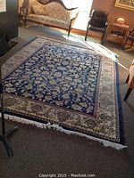 Full view of rug laid flat on floor showing overall pattern and border
