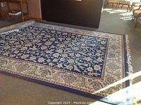Full view of unrolled rug showing overall pattern and condition
