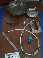 Overview of all sterling silver pieces and turquoise jewelry arranged on wood surface