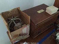 Boxed costume jewelry and wooden jewelry box on table