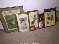 Wide view of assortment of framed and unframed prints including Collier's cover, bird illustrations, and other vintage prints.