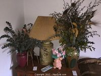 Overall view of the lamp and decor items grouped together, showing the lamp, vases, planter, and dried floral decorations.