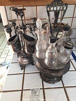 Overview of all silver plate pieces including candle sticks, condiment set, and pedestal stand