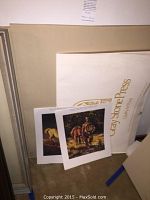 Photo showing several Native American-themed prints leaning against a wall, including a visible Jaray Stone Press folder or backing.