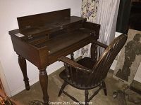 Angle of the spinet desk showing hinged top and chair in front.