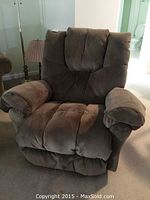 Full frontal view of the Havertys reclining rocker chair showing padded armrests and plush cushioned backrest with visible stitching.