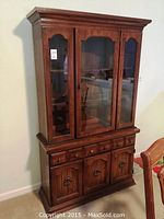 Full front view of two-piece china cabinet showing overall design and finish
