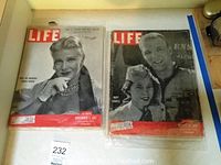 Two LIFE magazines in plastic dust covers, showing the front covers side by side on a flat surface.
