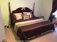 Front view of assembled king bed with bedding and pillows