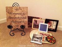 Full view of the art decor pieces with the large proverb plaque in metal stand and various smaller decorative pieces arranged around it.