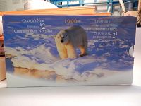 Photo of original sealed presentation box showing a polar bear on ice and text describing the 1996 Uncirculated $2 Coin and Bank Note Set from Canada.