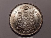 Obverse side of 1965 Canadian 50 cent silver coin showing the detailed Canadian coat of arms and inscriptions.