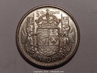 Obverse side of the 1958 Canadian 50 cent silver coin showing the coat of arms with lion and unicorn supporters, crown, and Canadian maple leaves.