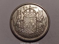 Obverse side of 1957 Canadian 50 cent silver coin showing detailed coat of arms with two lions holding flags, denomination and date.