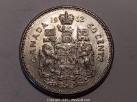 Close-up of the obverse side of the 1962 Canadian fifty cent silver coin showing the Canadian coat of arms and dating.