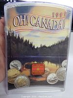 Front view of the 1999 Oh Canada! Canadian Coin Set sealed in original plastic packaging showing the Canadian wilderness artwork and coin illustrations.