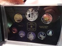 Photo showing the proof set coins arranged in a black case, featuring various Canadian coins including a large silver dollar and other denominations.