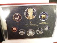 Coins displayed in protective clear holder showing all seven proof coins including 1 cent, 5 cents, 10 cents, 25 cents, 1 dollar, 2 dollars, and 20 cents coins with Canadian designs.