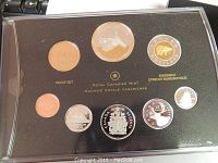 Display of all eight coins in black foam insert inside presentation case with Royal Canadian Mint logo and text in gold.
