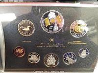 Full set of seven circulating proof coins and commemorative silver dollar in black holder