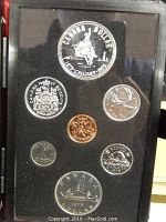 Full view of six proof coins from 1975 Canadian Calgary theme, including silver dollar, half dollar, quarter, dime, nickel, and penny.