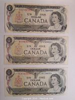 Front view of three 1975 Canadian one dollar bills with visible serial numbers.