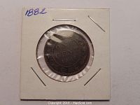 Full front view of the 1882 Canadian one cent coin in white cardboard holder with clear plastic window showing 'ONE CENT 1882' and decorative wreath design.