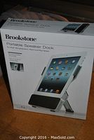 Box of Brookstone Portable Speaker Dock showing product name and compatibility with iPad 2 and 3rd generation and iPad tablets.