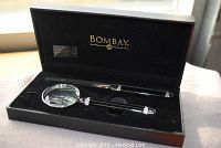Magnifying glass and letter opener set in original black box with Bombay Company branding, showcasing gem decoration and overall condition.