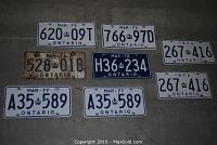 Front view of 8 Ontario license plates ranging from 1972 to 1978 with varied conditions, some rusty and some in better shape.