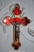 Front view of the red enamel crucifix cross pendant with silver-tone Jesus figure, showing detail and colors.