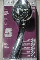 Close-up of shower head showing chrome finish and multiple spray nozzles arranged in concentric circles. Labels visible indicating 5 settings: spray, power massage, spray/massage, aeration, pause. No-slip handle grip shown.