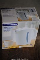 Boxed Durabrand electric kettle showing product image, brand, and feature details.