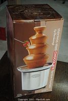 Original retail packaging box displaying an image of the stainless steel chocolate fountain with flowing melted chocolate.