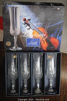 Set of four Cristal d'Arques Longchamp crystal champagne glasses in original box, featuring violin image on packaging.
