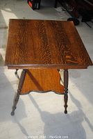 View of the square top showing rich tiger oak grain and molded edge.