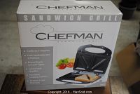 Box of Chefman sandwich grill showing product features and image of grill with sandwich inside