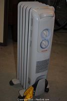 Front view of white Honeywell oil-filled portable radiant heater showing control panel with two dials and handle on top.