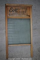 Full front view of antique glass laundry scrub board showing the glass scrubbing panel and wooden frame.